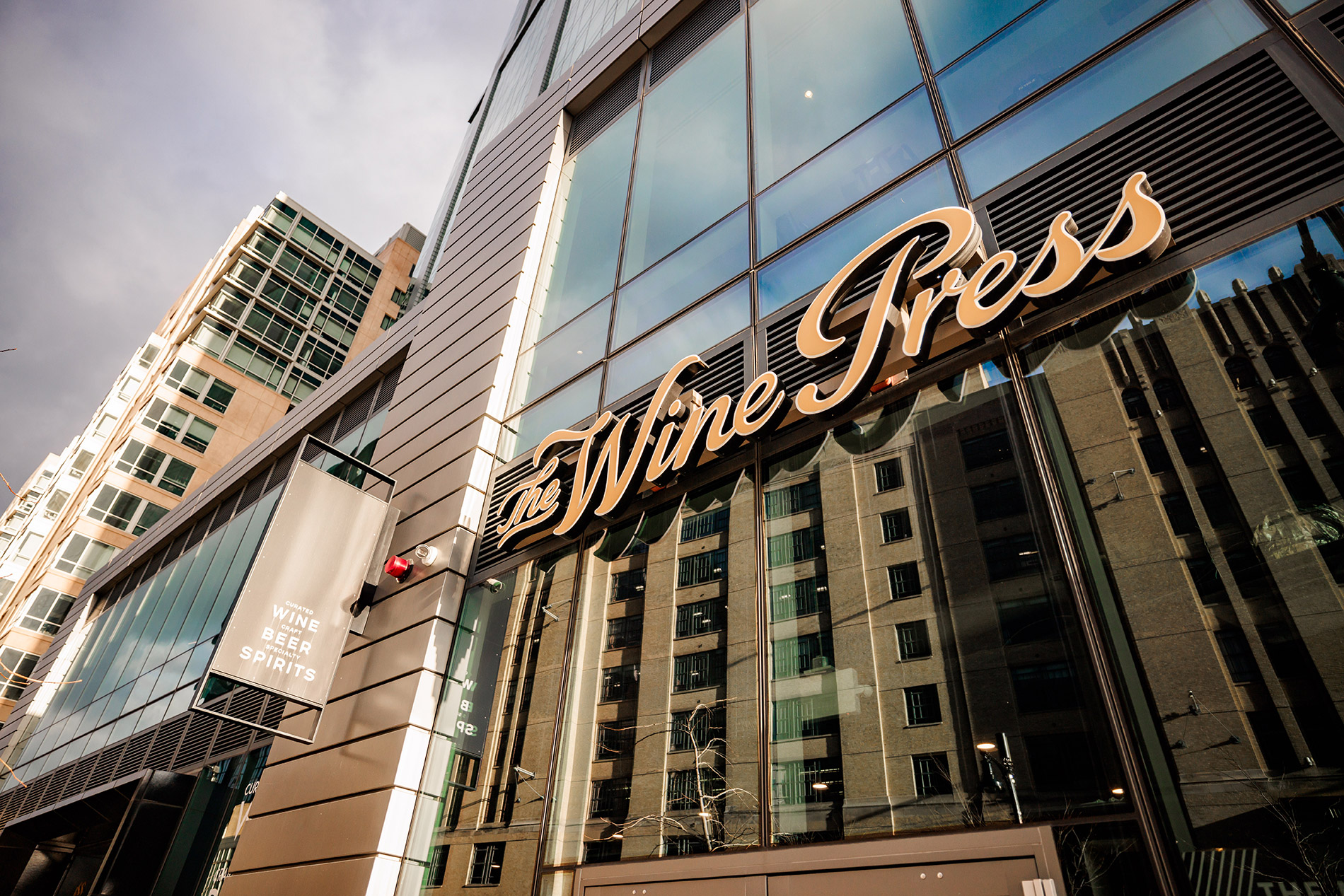 A building in the city of Boston with a sign that says Wine Press.